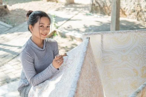 Portrait of a worker drawing batik pattern Stock Photos