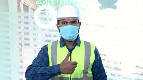 Portrait of worker engineer wearing mask doing happy thumbs up gesture with hand Stock Footage 136206780