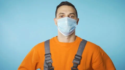 Portrait of Worker man wearing white medical face mask Stock Footage 143549161