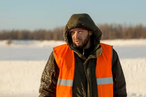 Portrait of a worker medium plan on the ice of a river 스톡 사진