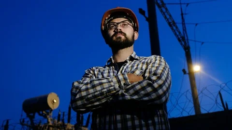 Portrait of a worker at night on the background of an electrical substation Stock Footage 95631456