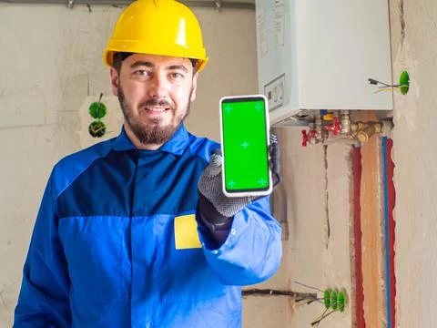 Portrait of worker or engineer in blue work clothes and yellow safety helmet Stock Photos