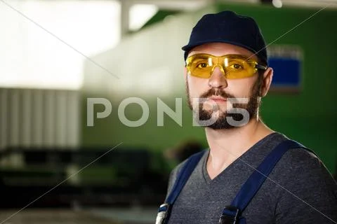 Portrait Of Worker In Overalls, Steel Factory Background