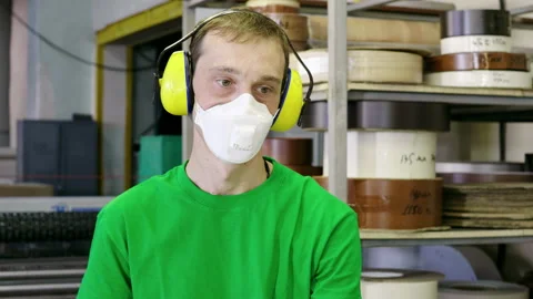 Portrait of a worker in a protective mask working in a furniture factory. 4K Stock-Footage 153326443