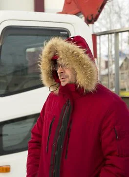 Portrait of a worker in a red jacket at a construction site 写真素材