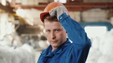 Portrait of worker wearing helmet in workshop, he is proud of working in factory Stock-Footage 143030938