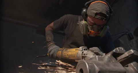 Portrait of a worker working with a grinder Видео 144589357