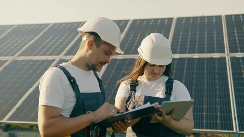 Portrait of workers in front of solar panels discussing information data Stock Footage 255062918