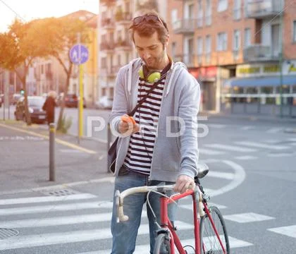 Portrait Of Young Adult Man Crossing Inattentively The Street Distracted By H