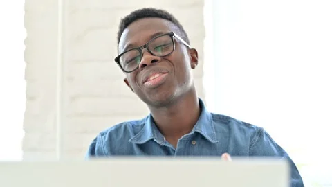 Portrait of Young African Man doing Online Video Chat on Laptop Stock Footage 127780935