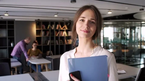 Portrait of young and attractive woman who is working manager in business office Stock Footage