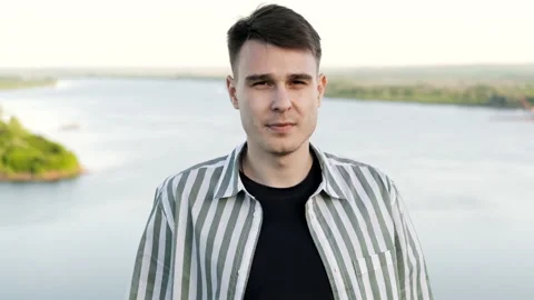 Portrait of a young and handsome guy of caucasian appearance outdoors. High Vídeos de archivo 162194133