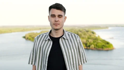 Portrait of a young and handsome guy of caucasian appearance outdoors. High Video stock 162194146