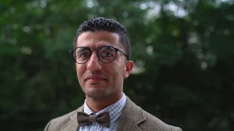 Portrait of a young Arab smiling man in glasses. Slow motion Video stock 80980768