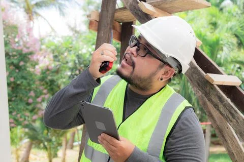 Portrait young Asian engineering architect foreman male wearing safety vest.. Stock Photos