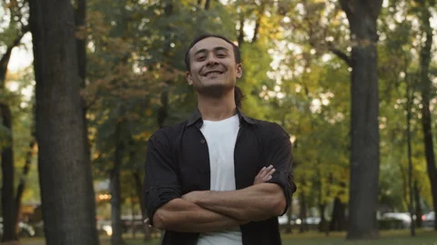 Portrait of a young asian man looking at the camera and smiling in the middle of Stock Footage 252122153