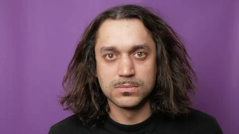Portrait of a young attractive guy, he is looking at the camera and smiling. Video stock 252116721