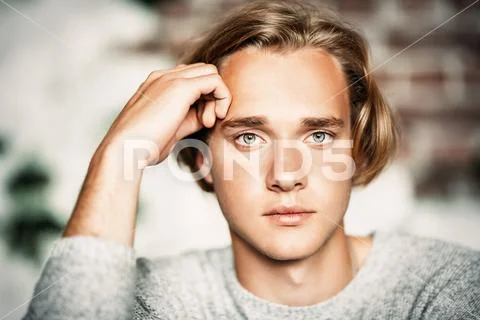 A portrait of a young attractive man posing indoor. Casual men fashion, beaut Stock Photos