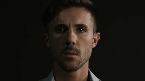 Portrait young attractive serious man looking at the camera Video stock 80303543