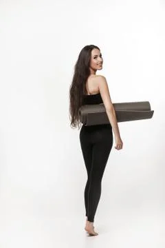 Portrait of young attractive woman doing exercises. Brunette with fit body ho Stock Photos