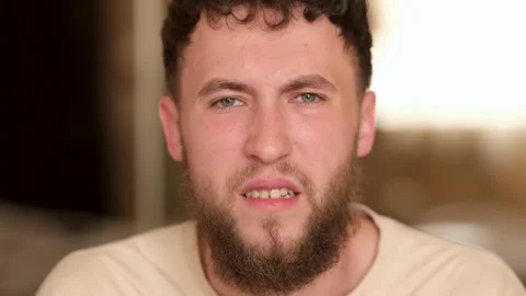 Portrait of a young bearded guy with different emotions on his face Stock Footage 279878497
