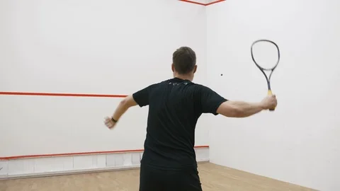 A portrait of a young bearded man practicing to play squash, slow motion Stock Footage 124390301