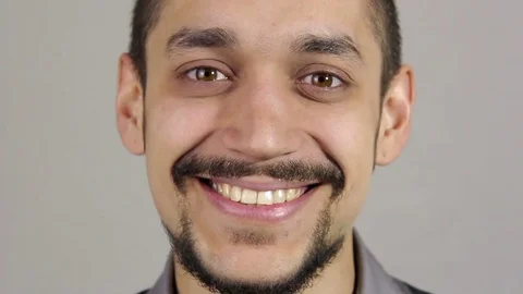 Portrait of a young bearded man. Smiling looking at the camera. Stock Footage 73721054
