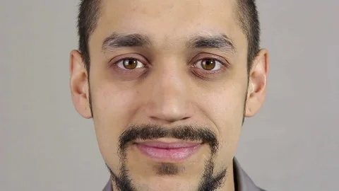 Portrait of a young bearded man. Smiling looking at the camera. Stock-Footage 74620127