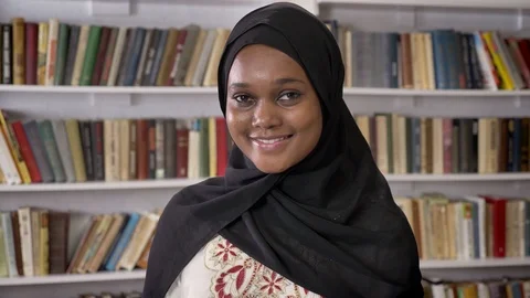 Portrait of young beautiful african muslim women in hijab looking into camera Stock Footage
