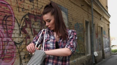 Portrait of young beautiful dark-haired woman wearing trendy shirt standing Stock Footage 65417280
