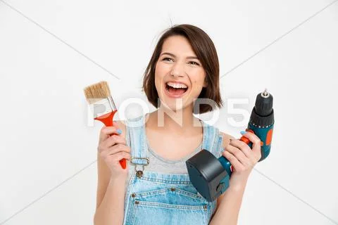 Portrait of young beautiful girl, screaming, holding painting Stock Photos