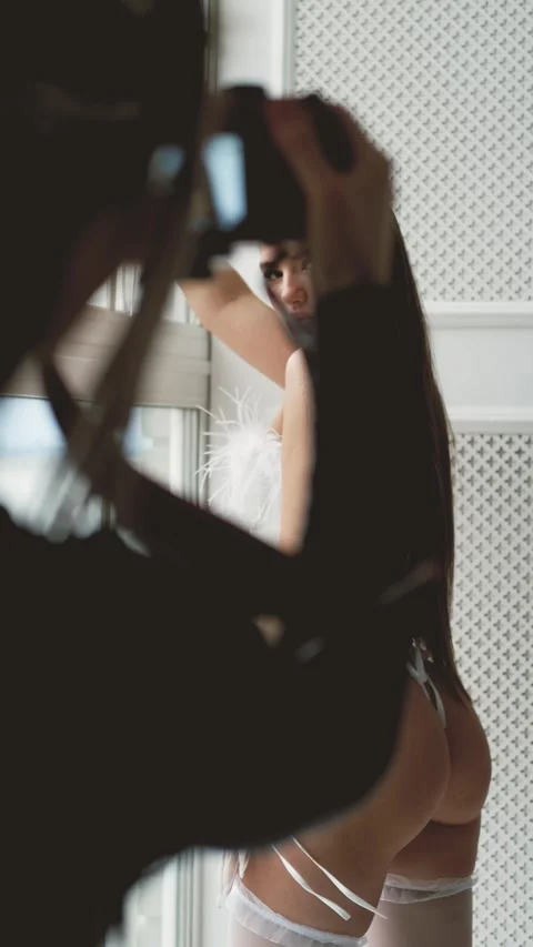 Portrait of young beautiful model posing in white lace lingerie, corset and Stock Footage 285868617