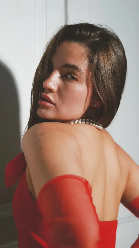 Portrait of a young beautiful model posing in lingerie, in red gloves and a vest Vidéo 289400793