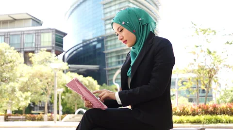 Portrait of young beautiful Muslim wearing Hijab using tablet computer 스톡 동영상 34386053
