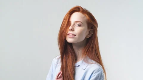 Portrait of young beautiful red-haired girl on white background, smiling Stock Footage 120917901