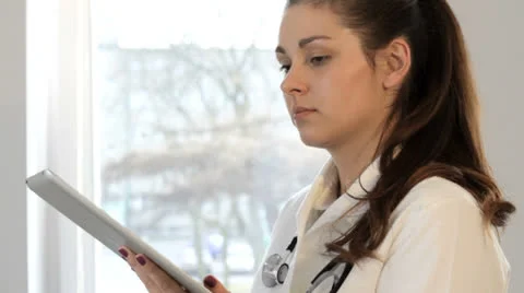 Portrait of young beutiful doctor with tablet Stock Footage 22949475
