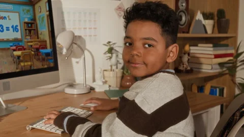 Portrait of Young Black Boy Using Interactive Computer App for Doing Sums Stock Footage 334973074