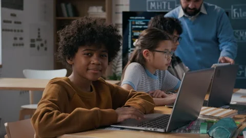 Portrait of Young Black Boy Working on Laptop in Coding Class Stock Footage 306980792
