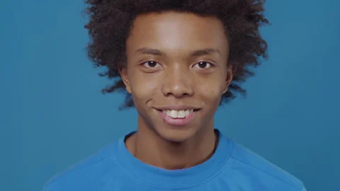 Portrait of a young black guy close up turning his head, looking at the camera Stock Footage 254954594