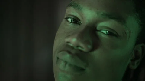 Portrait of Young Black Man Looking at Camera with Shifting Neon Lighting Stock-Footage 337405639
