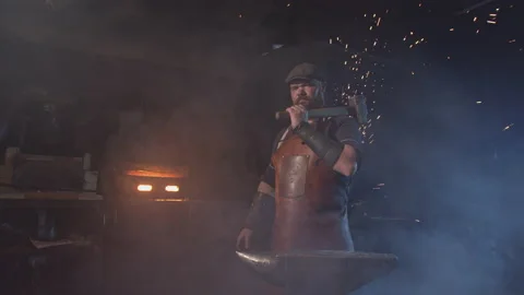 Portrait of a young blacksmith with a hammer on his shoulder Video stock 146580533