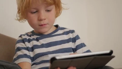 Portrait of a young blonde boy with a tablet computer 스톡 동영상 69208499