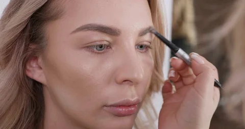 Portrait of a young blonde girl getting a mekup in a beauty salon Stock Footage 104251053
