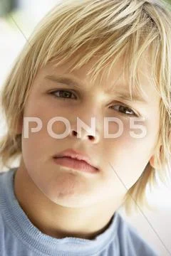 Portrait Of Young Boy Frowning Stock Photos
