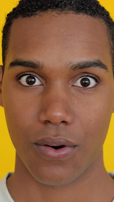 Portrait of young boy looking surprised to the camera over yellow background Stock Footage 277551095
