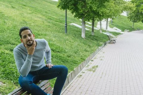 Portrait of a young boy posing in a park Stock Photos