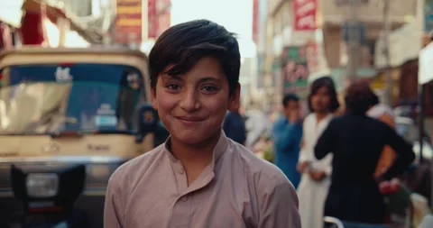 Portrait of a Young boy smiling in Quetta Bazaar street Stock Footage 243598130