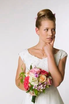 Portrait of a young bride, musing, hand to chin Stock Photos