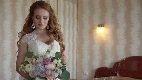 Portrait of young bride standing in a beige room. Stock Footage 70739867