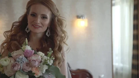Portrait of young bride standing in a beige room. Stock Footage 70739975
